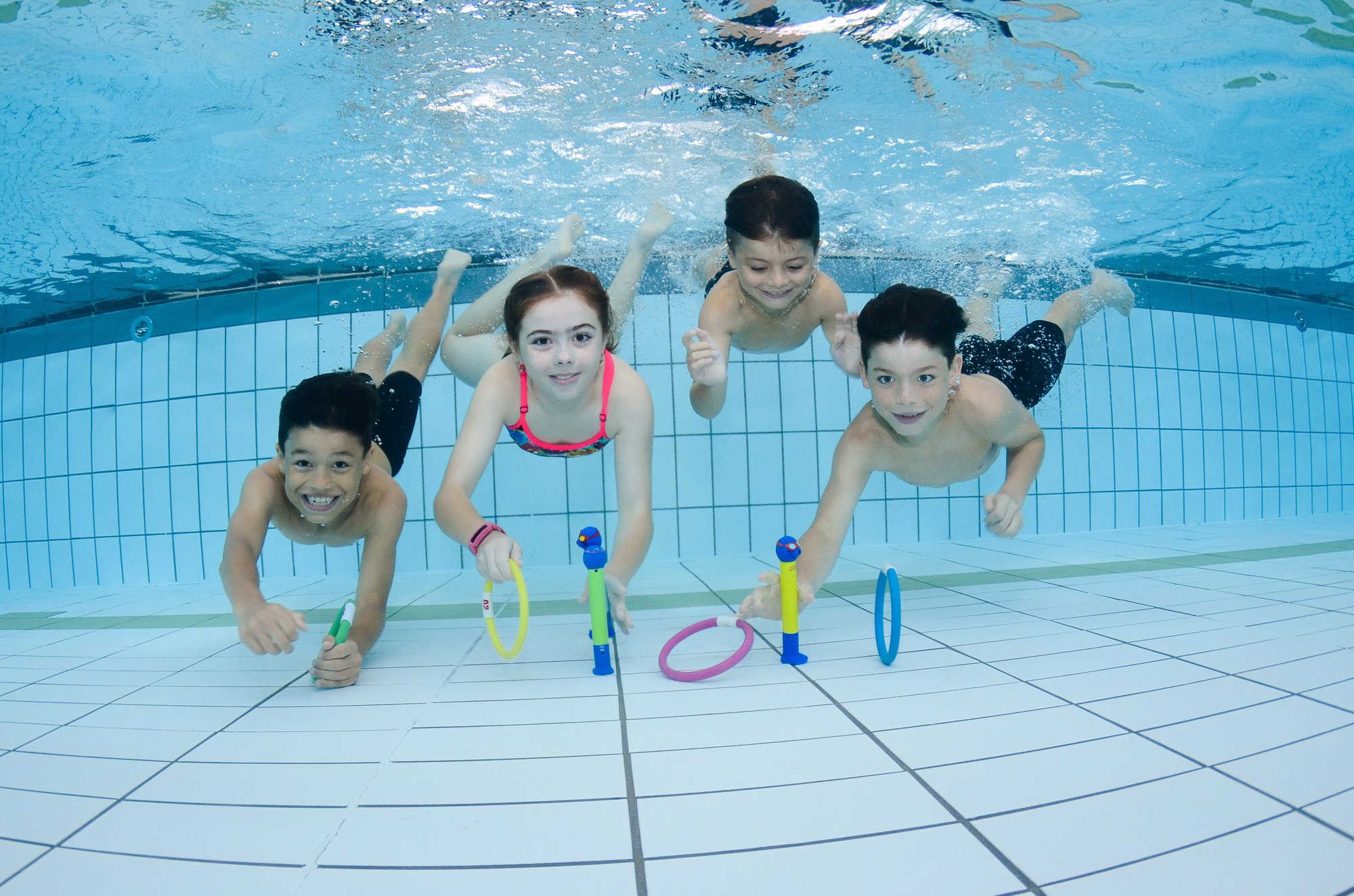Swim teacher providing safe, supportive instruction during a supervised adult swimming lesson