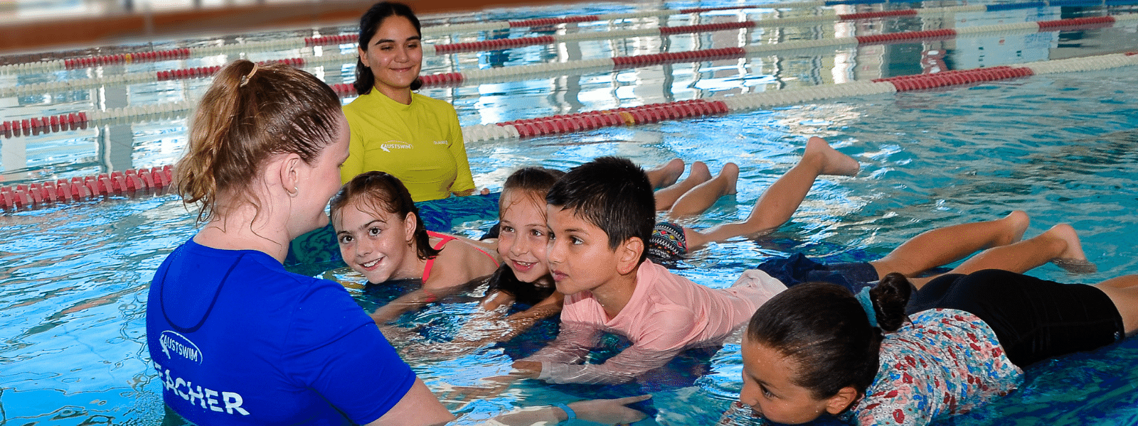 Children practising underwater swimming and water safety skills in a supervised learn to swim program